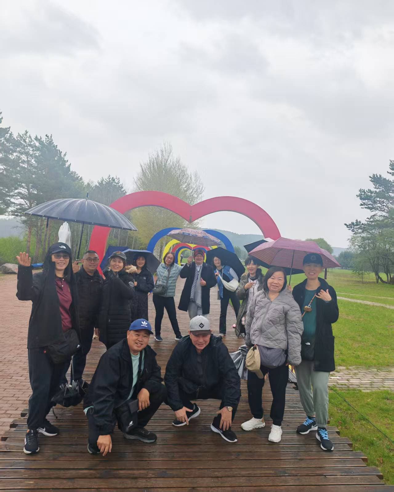 JUN-AIR group under a rainbow arch on a rainy day