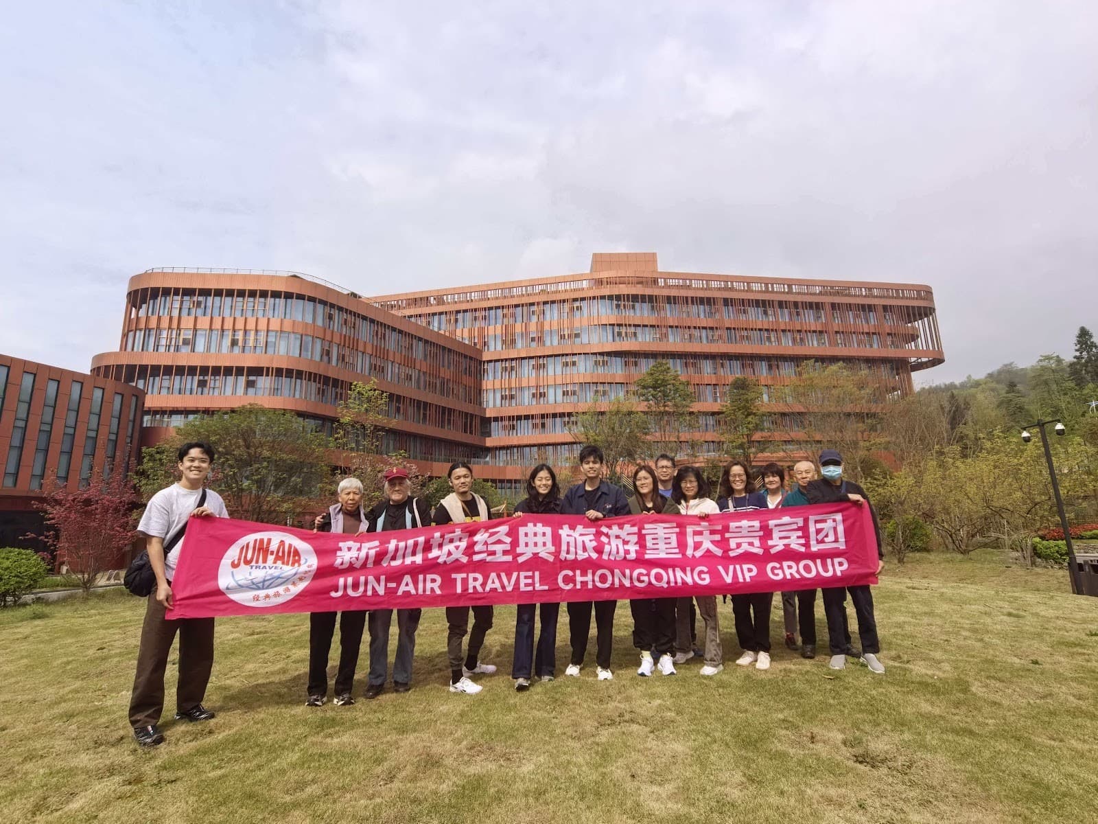 JUN-AIR tour group with their banner in China