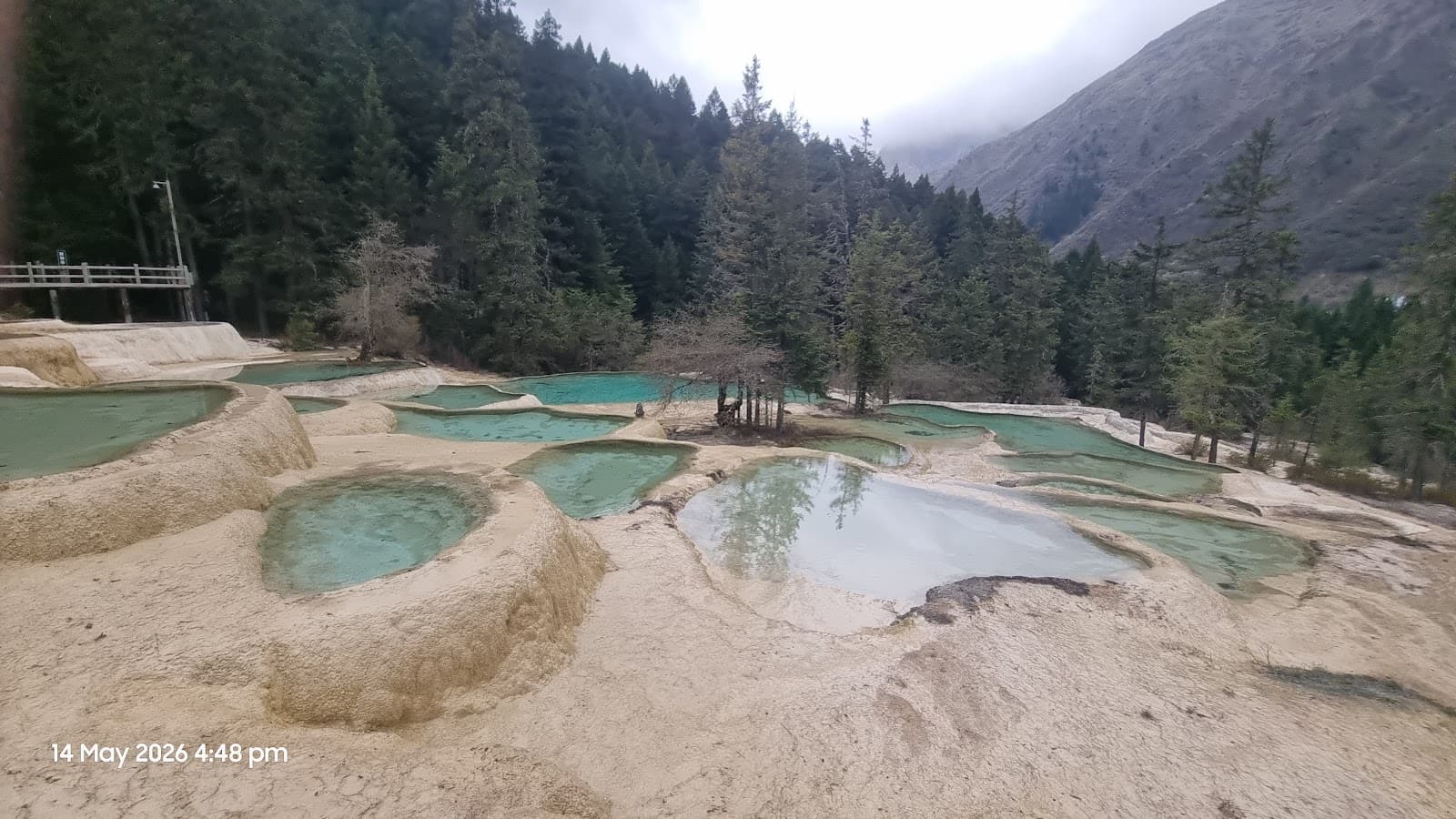 Couple posing at Huanglong's travertine terraces
